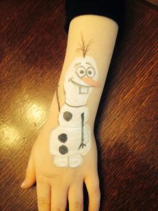 Artist Ariana- frozen theme face painting, snowflakes, wintery scene, olaf snowman face painting, simple hand or cheek art of full face painting